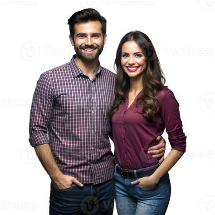 a man and woman standing next to each other on a red carpet at an event