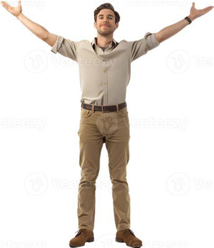 a man standing with his arms crossed in front of him and looking at the