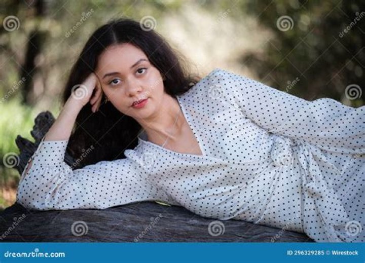 a woman laying on top of a white bed