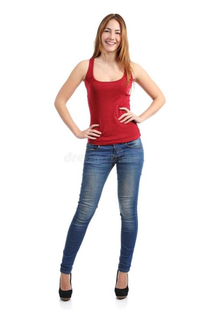 a woman standing in front of a brick fireplace holding two paddles and