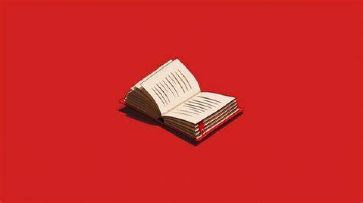 an open book with red writing on the page and some words written in