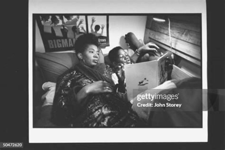 Author Terry McMillan cuddling w. boyfriend Jonathan Plummer & son