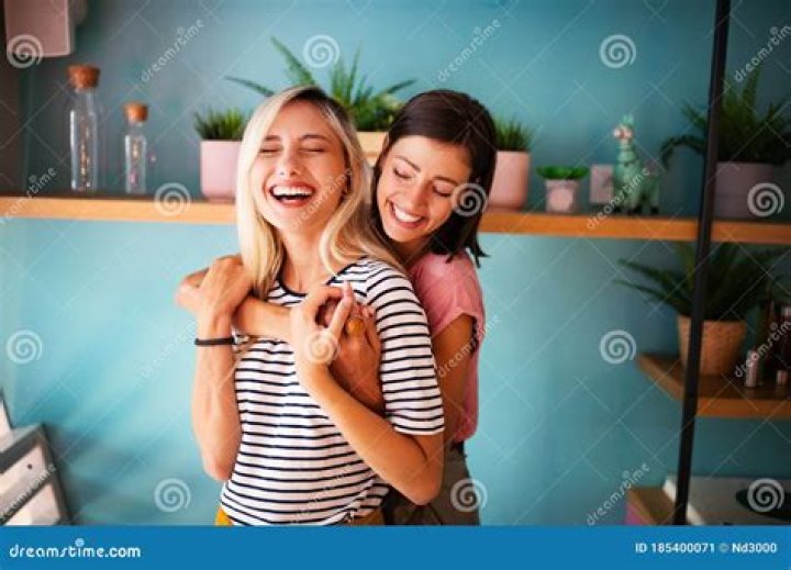 Cheerful Lesbians Embrace Passioantely and Have Fun Together Stock