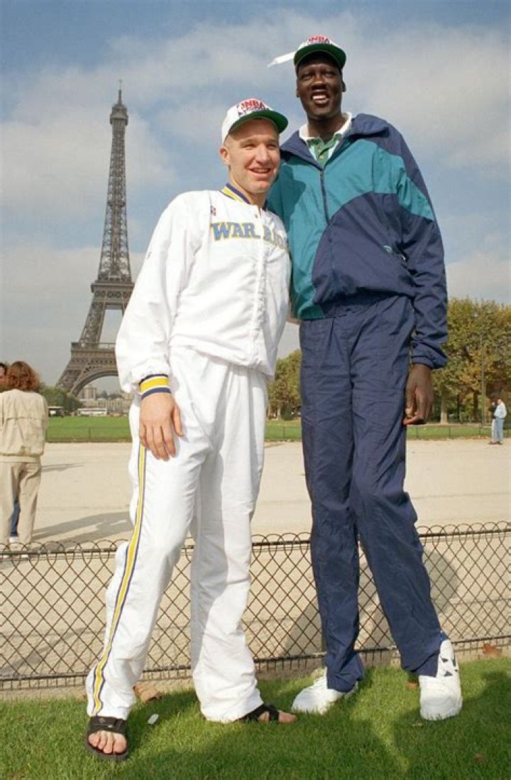 Chris Mullins and Manute Bol in front of the Eifel Tower. Ncaa