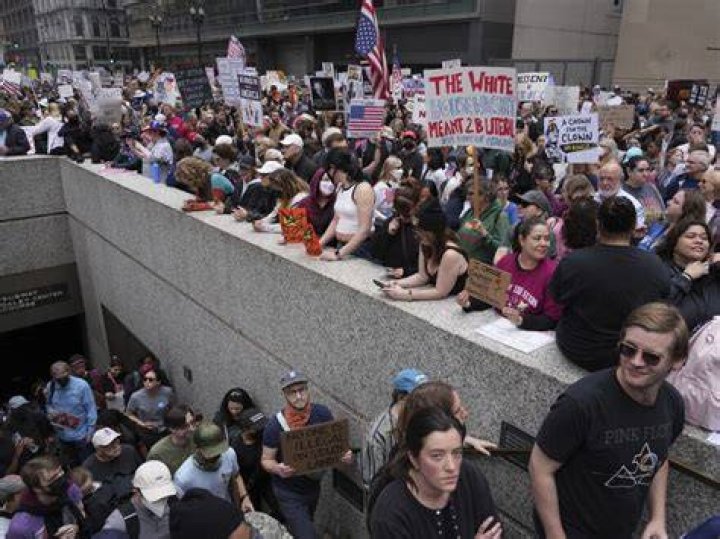 Demonstrators march to entrance of KKK national director Thomas Robb's