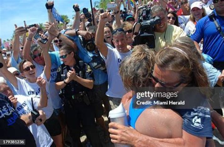 Diana Nyad gets a hug from her trainer Bonnie Stoll as she steps onto