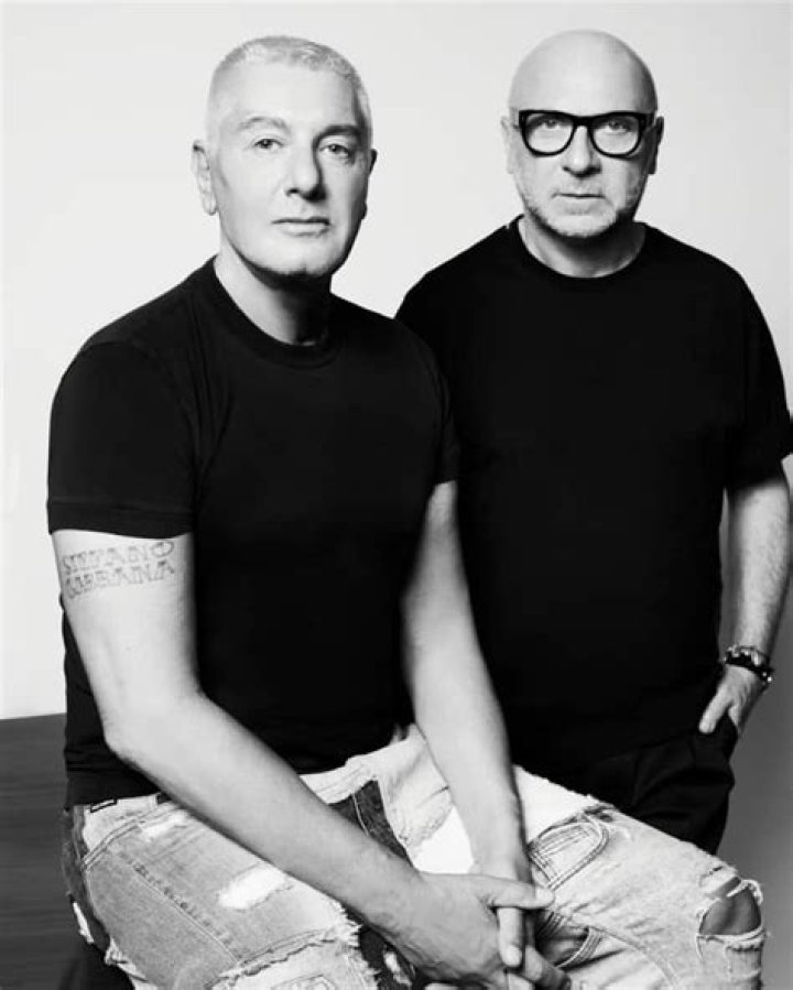 Domenico Dolce with his arm around Sutton Stracke in front of her boutique establishment.