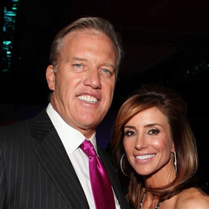 John Elway and his wife Paige at the Flight to Luxury Hangar Event 2012