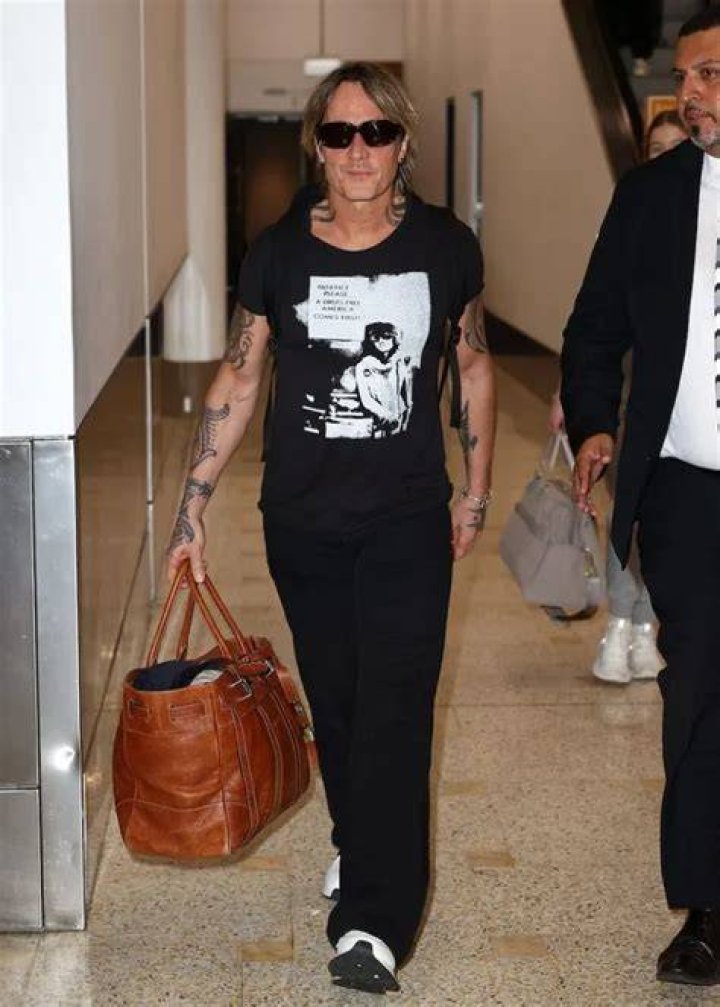 Keith Urban leaves wife Nicole Kidman as he arrives in Sydney with his
