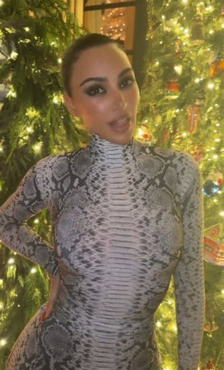 Kim Kardashian sticks out famous butt in tight snakeskin catsuit for new video as she plays mini gol