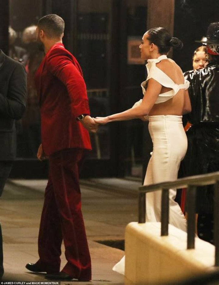Lucien Laviscount holds hands with Hannah JohnKamen at the British
