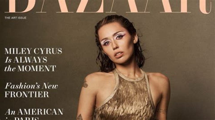 Miley Cyrus covers up in slinky silver gown to pick up two gongs at