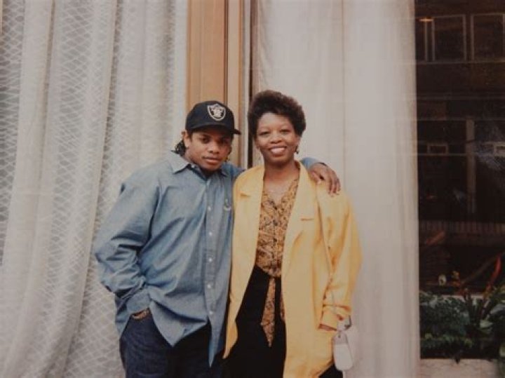 My mom posing with EazyE outside of a London hotel in the late 80s r