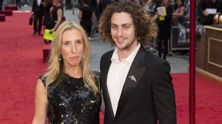 Sam TaylorJohnson, 52, and husband Aaron, 28, wear matching neutral