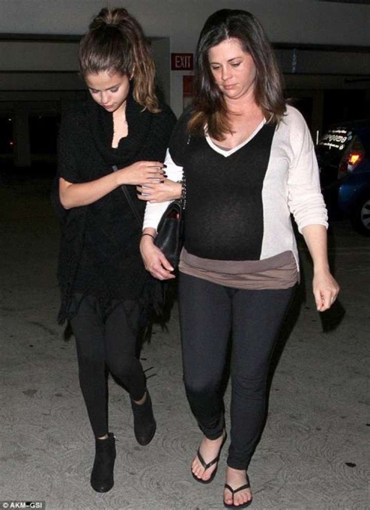 Selena Gomez keeps a protective hold of her pregnant mother on trip to