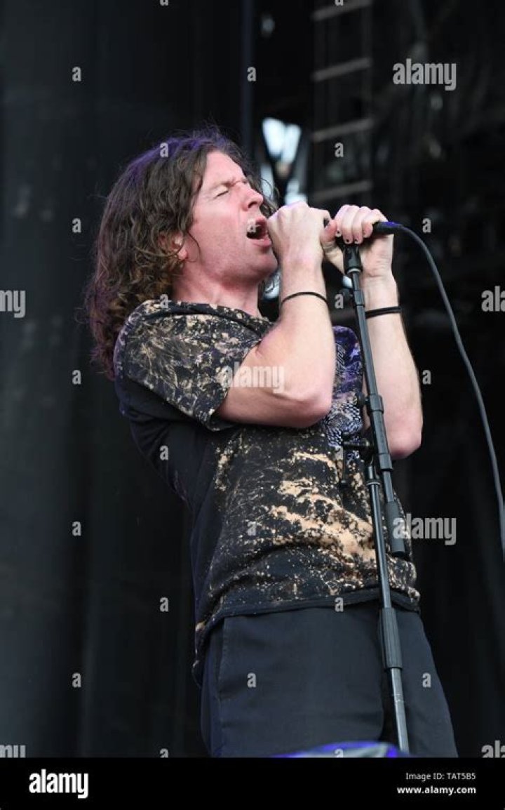 Singer Brendan Yates is shown performing on stage during a "live" stand