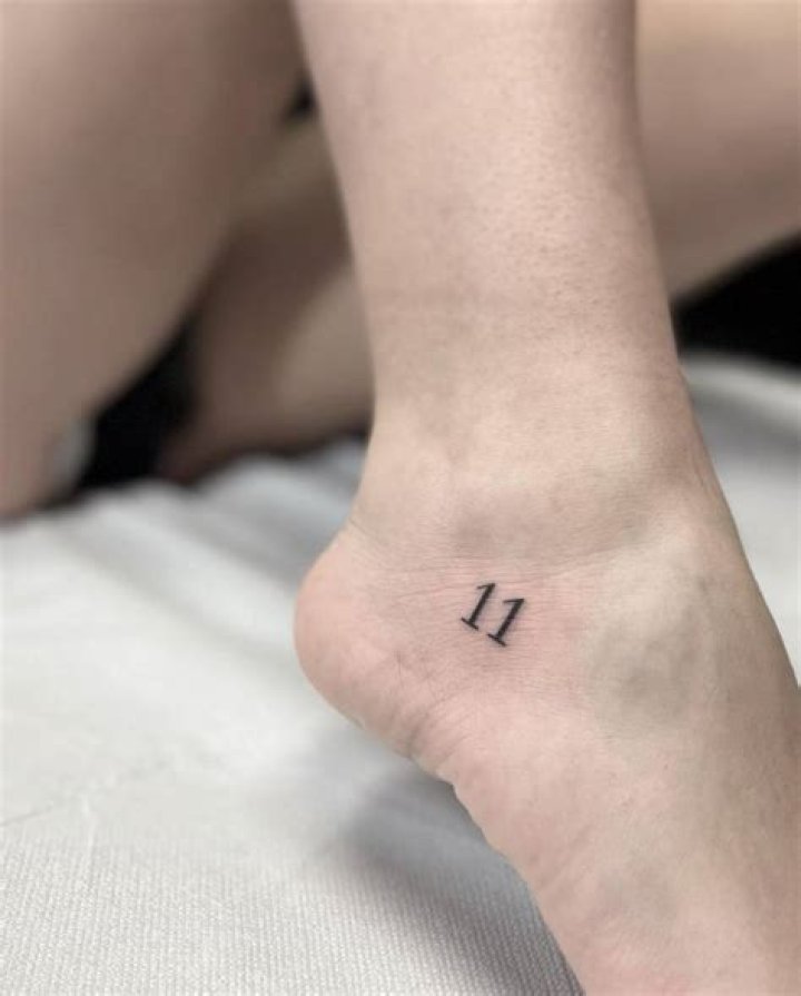 Tattoo of the number "777" located on the bicep.