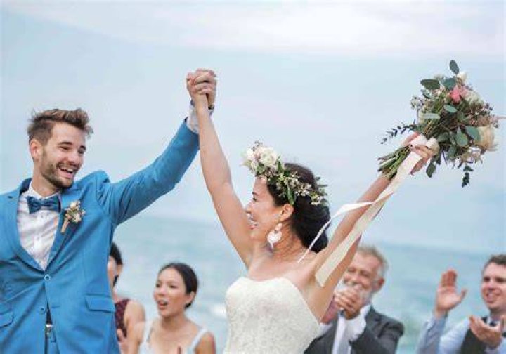 the bride and groom are posing for pictures outside in their wedding