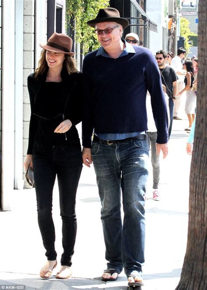 Tim Robbins takes romantic stroll holding hands with younger looking