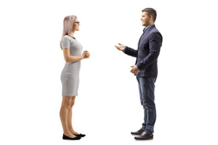 two people standing next to each other in front of a triangle with the