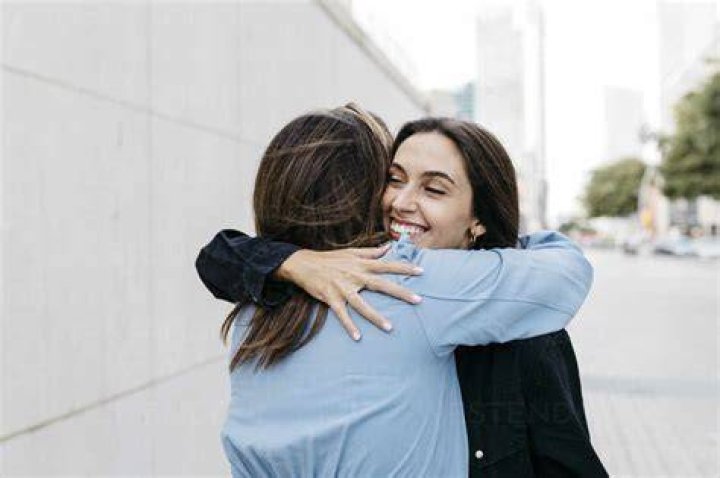 two women hugging each other at a party